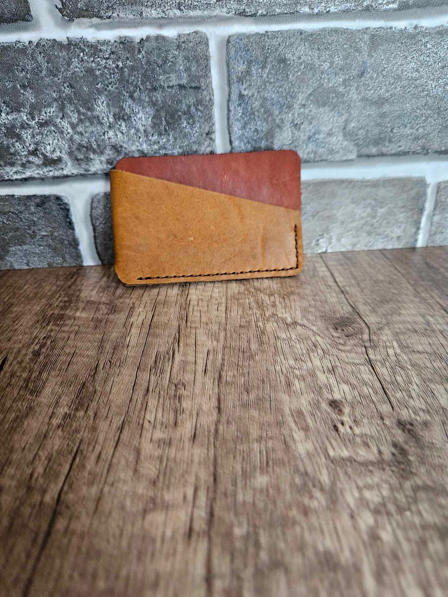 Tan leather wrap wallet with burgundy interior and contrast stitching