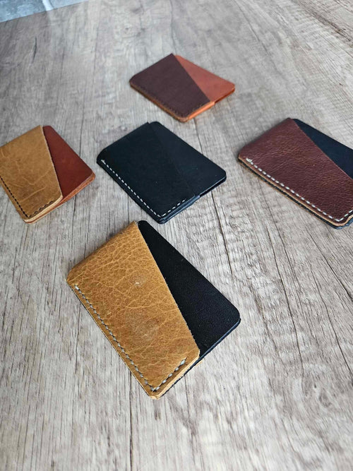 Slim leather wrap wallets, black and tan exterior with contrasting stitching