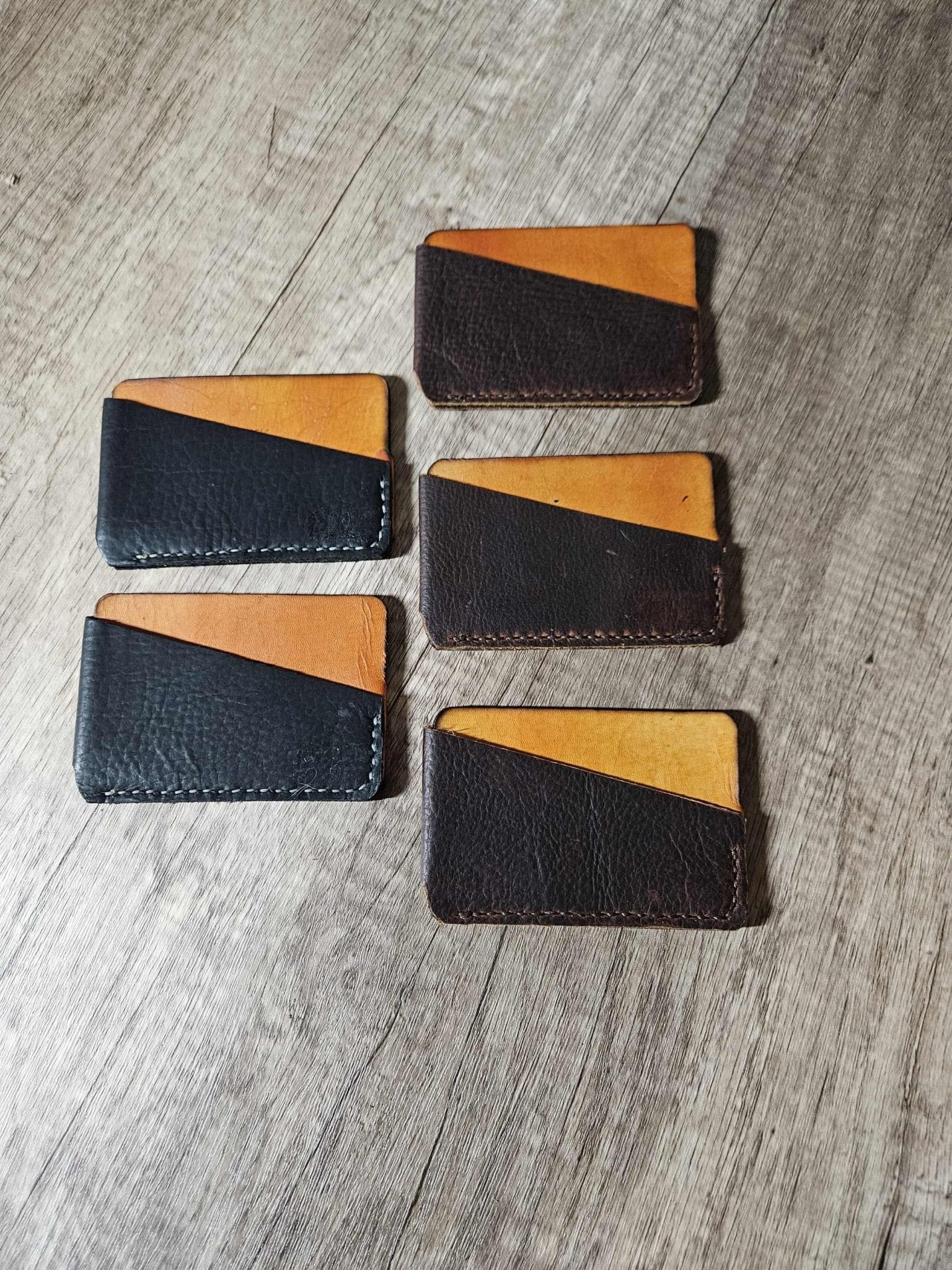 Set of slim leather wrap wallets with tan interiors and dark exteriors