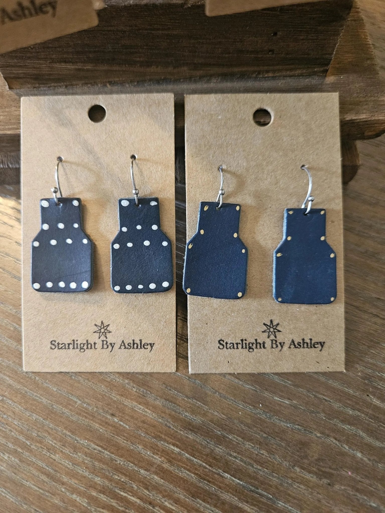 Blue geometric leather drop earrings with dot accents and silver hooks