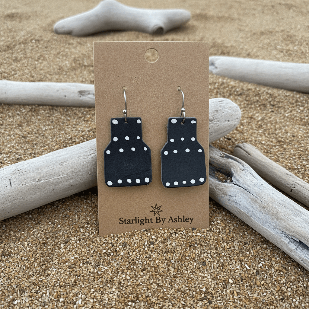 Blue geometric leather drop earrings with white dot pattern and silver hook backs