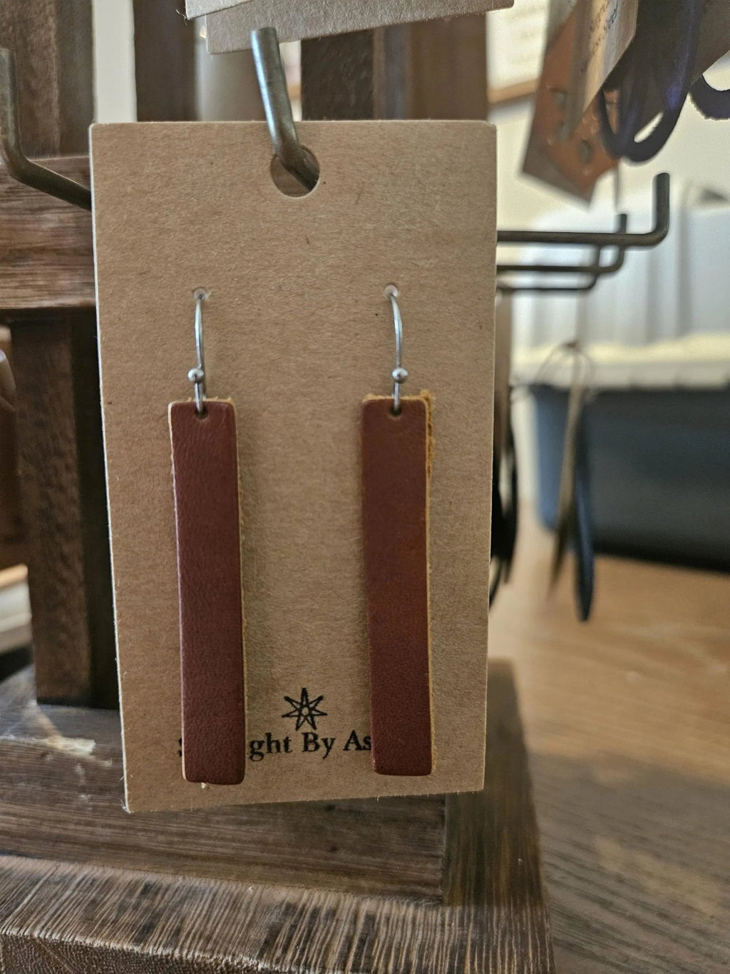 Brown leather rectangle drop earrings with silver hooks on kraft backing card