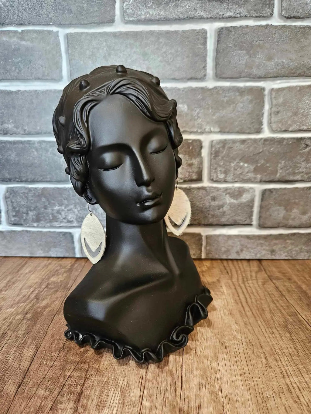 Hair-on-hide leather teardrop earrings on mannequin, tan fur teardrops