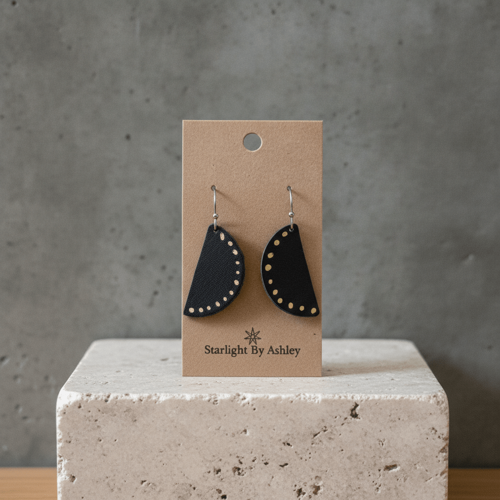Black leather half-circle earrings with dotted edge and fishhook closures