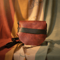 Handmade red leather crossbody purse with curved flap and black adjustable strap