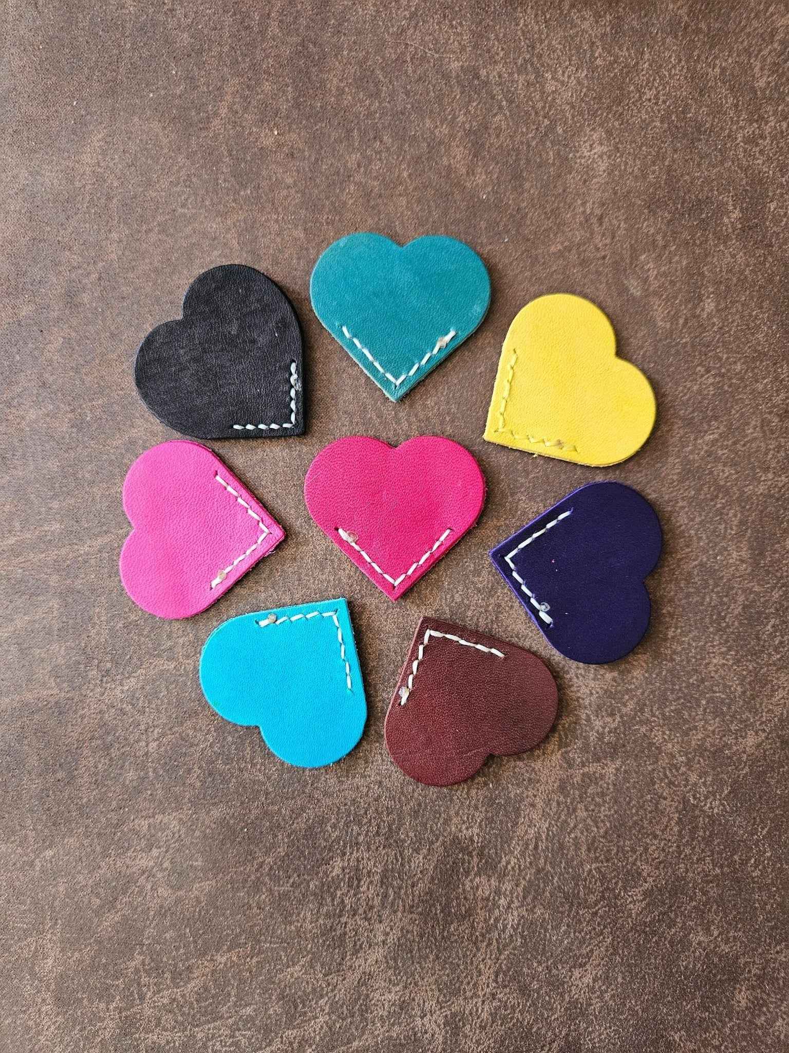 Assorted heart leather bookmarks with white stitching and metallic edge paint details
