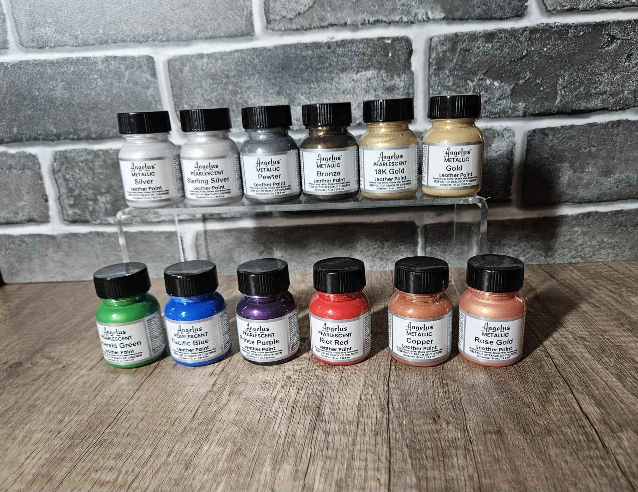 Metallic edge paint bottles displayed in a row with caps