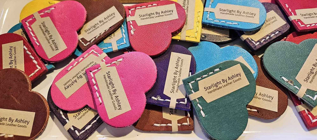 Assorted heart leather bookmarks in red, pink, teal, brown, navy, and yellow with stitching