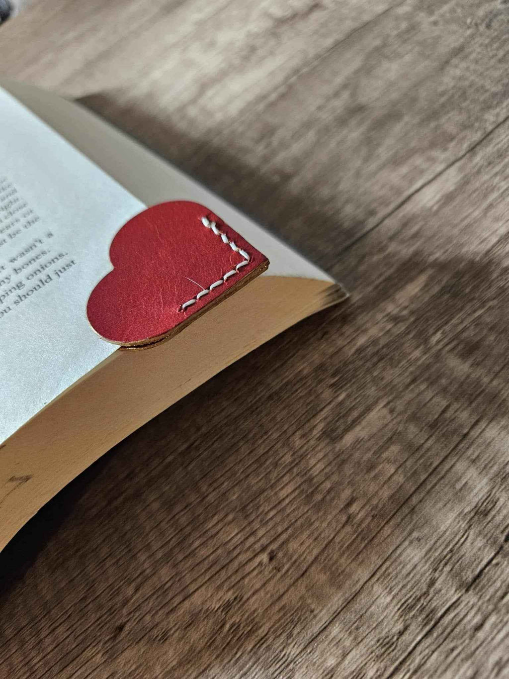 Red heart leather page corner bookmark with white dashed stitching