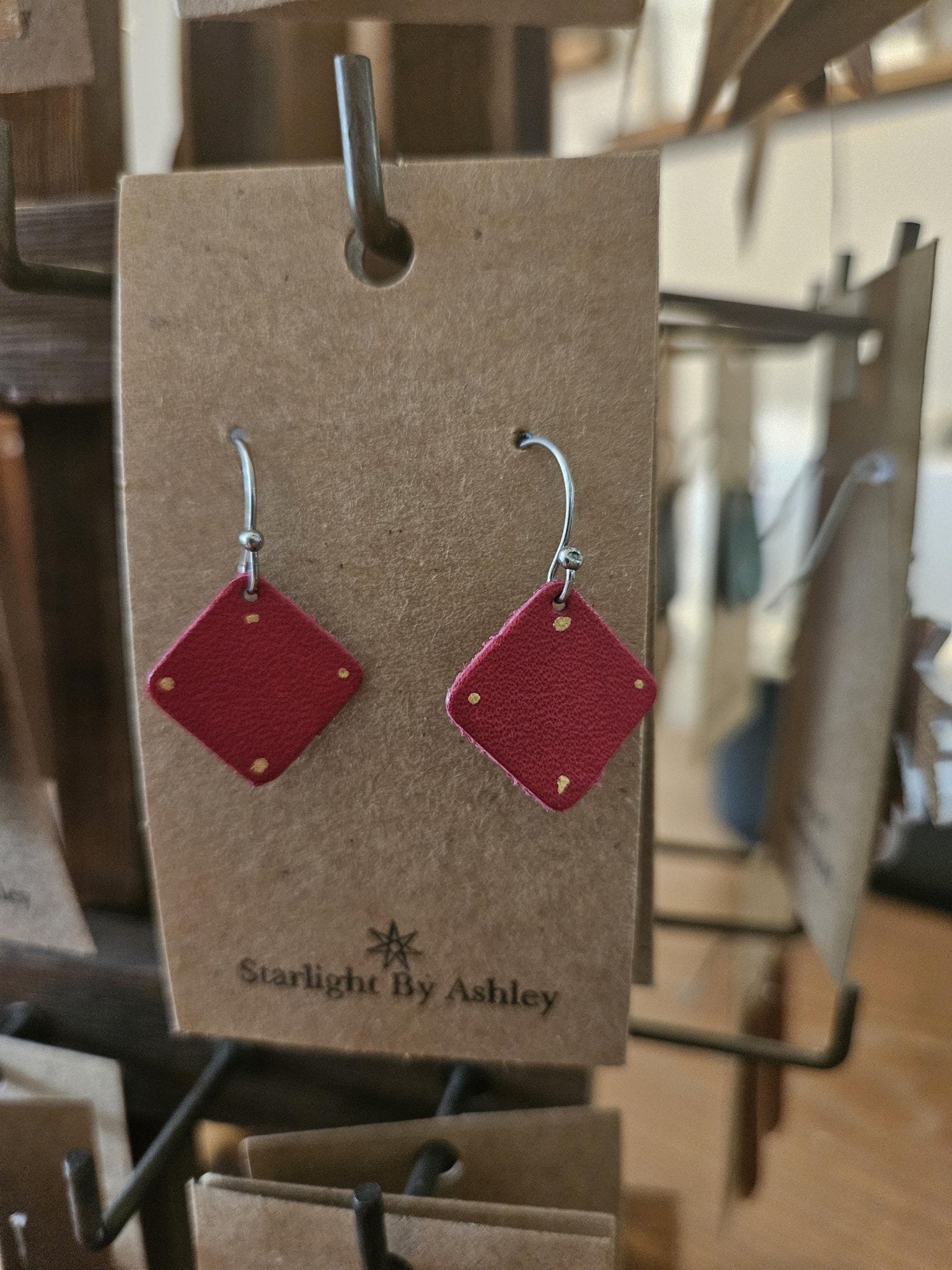 Red leather diamond earrings in pairs on a product card; silver hooks and red diamonds