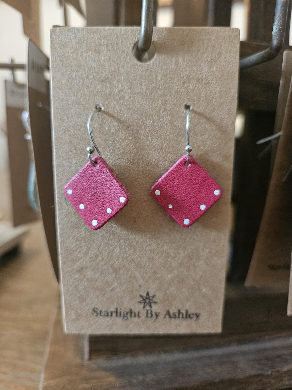 Red leather diamond earrings on display card with silver hooks and red diamond shapes