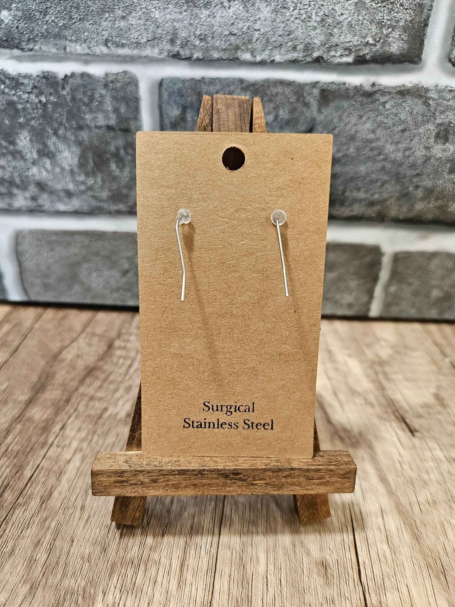 Red heart leather earrings on display card with surgical stainless steel ear wires