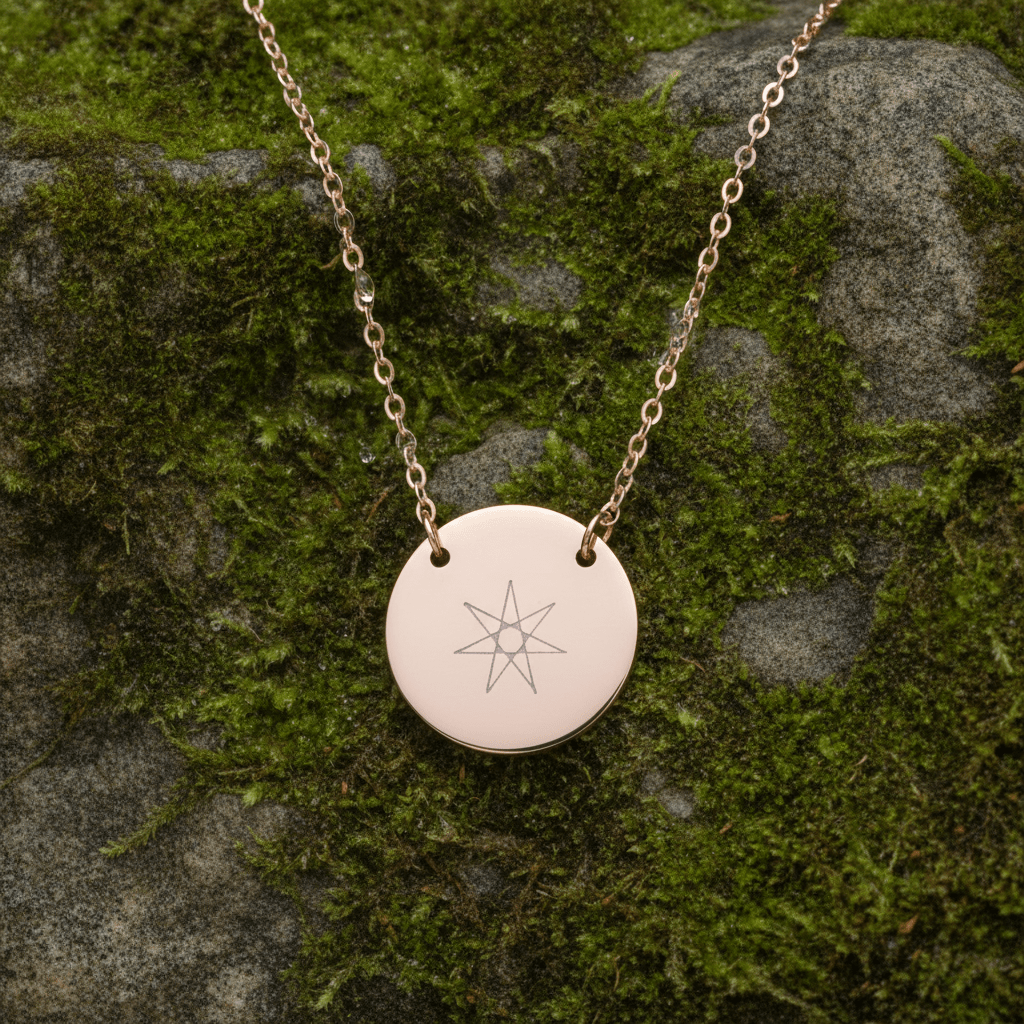 Gold-tone round disc pendant necklace with engraved star motif, front view