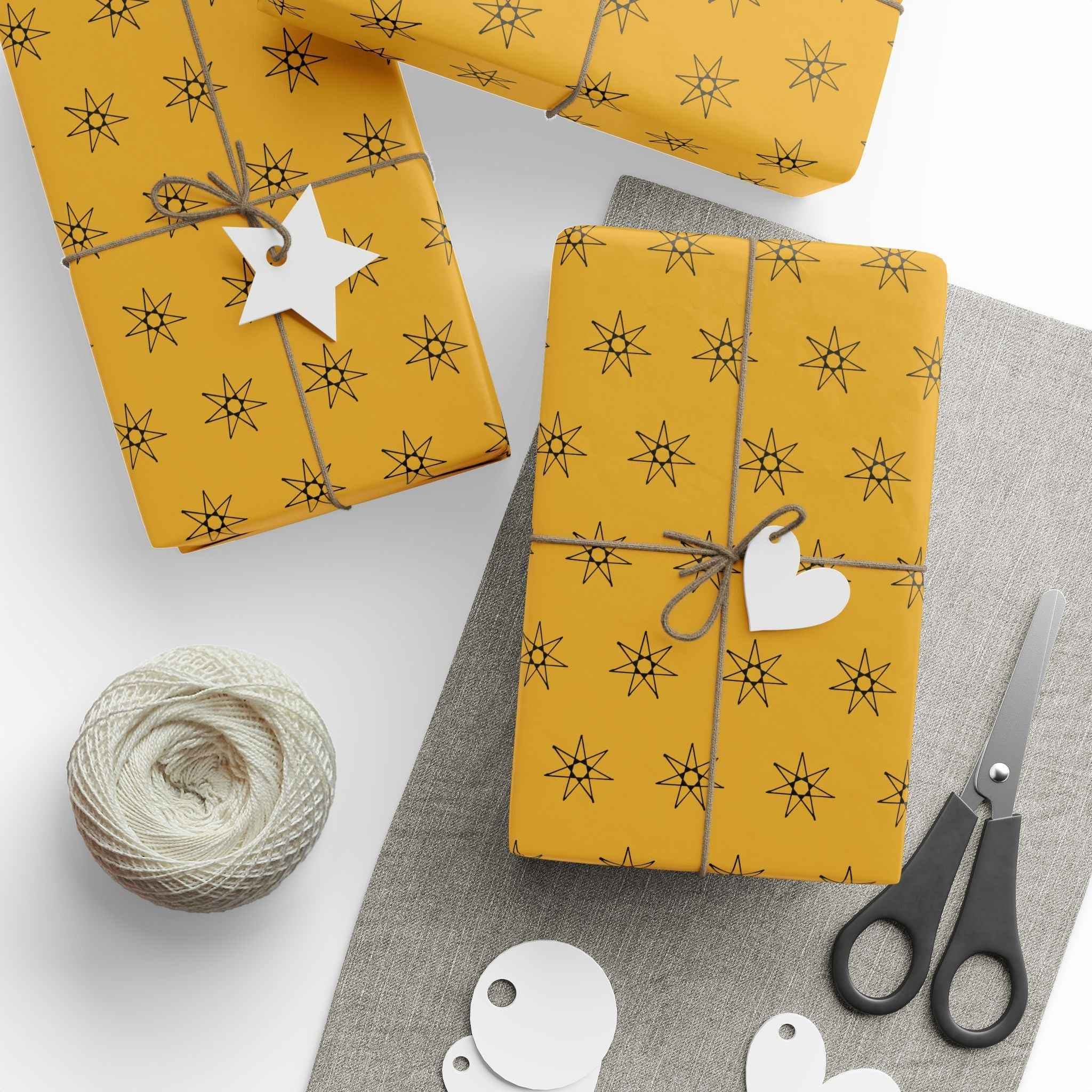 Yellow wrapping paper with seven-point star pattern, gift wrap pieces and tags