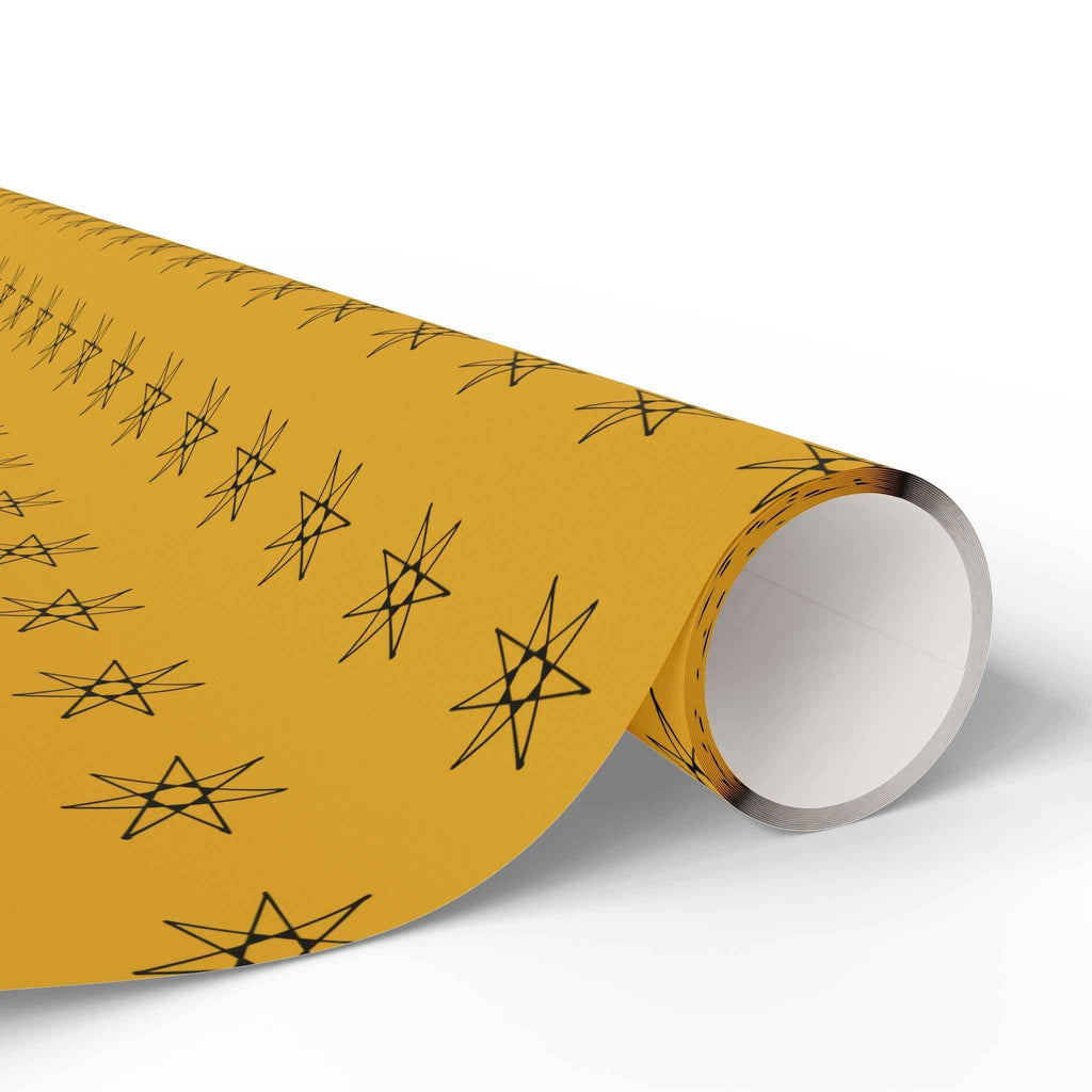 Yellow wrapping paper roll with black star pattern, rolled end and inner core close-up