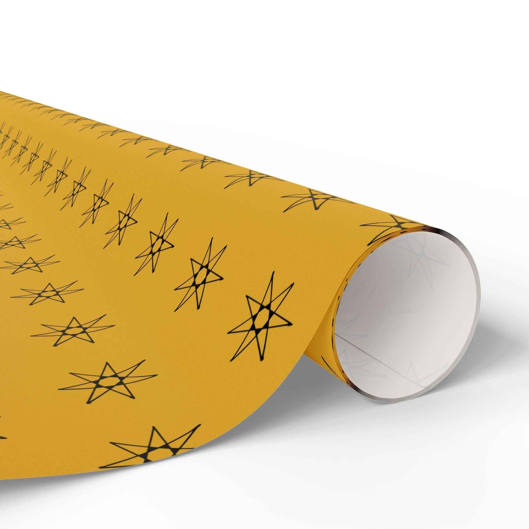 Yellow wrapping paper roll with seven-point star pattern, rolled edge visible