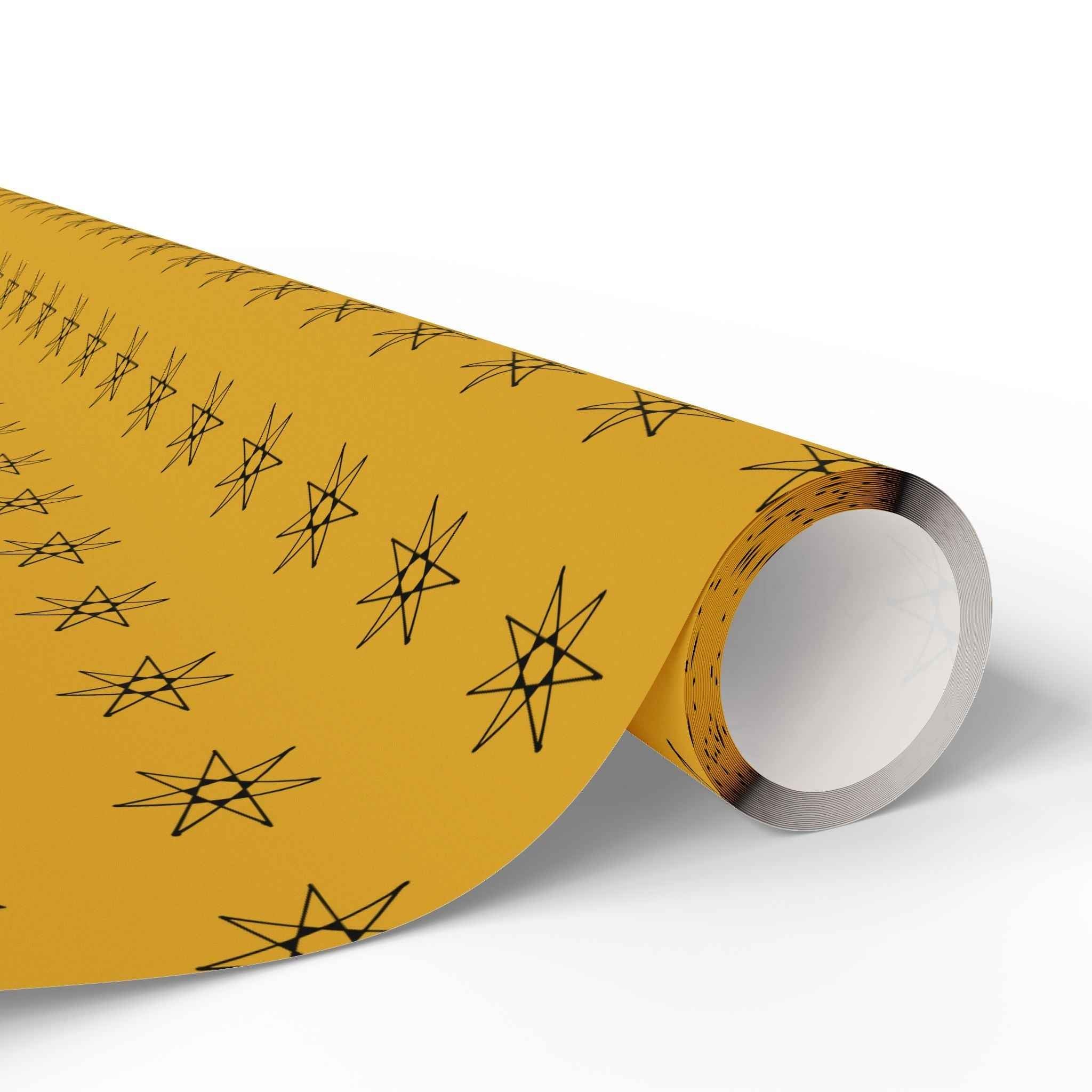 Seven-pointed star wrapping paper roll, yellow with black seven-point star pattern on core